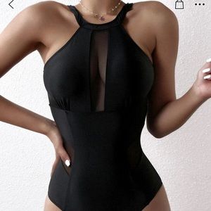 Black one piece swim suit. NEW AND NEVER WORN!